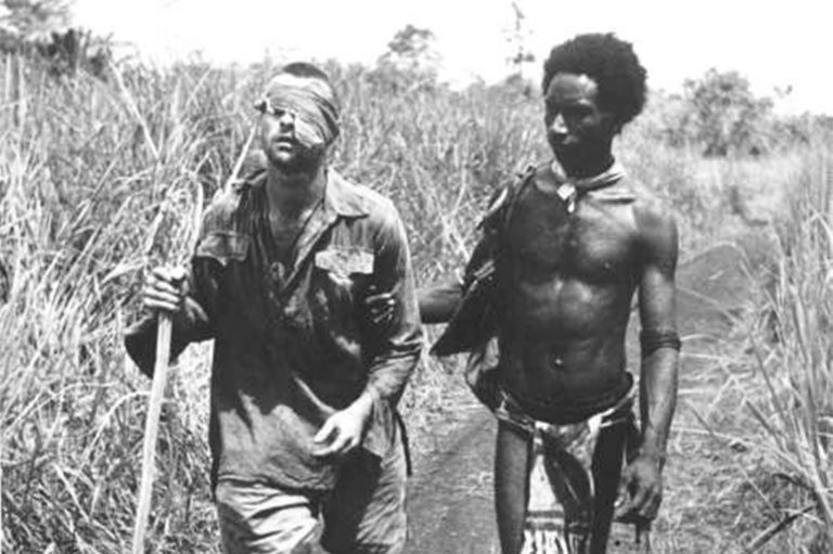 Australian Private George “dick” Whittington, Assisted By Raphael Oimbari, Papua New Guinean “fuzzy Wuzzy Angel,” Near Buna On Christmas Day, 1942.
