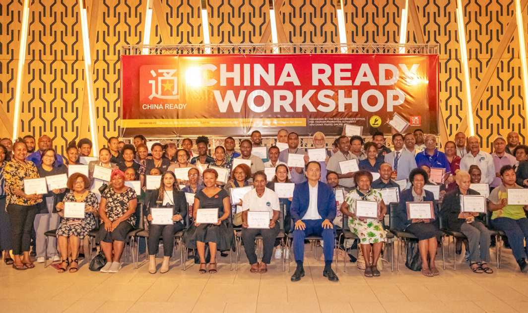 Participants from the China Ready workshop proudly holding their certificates with Dr Marcus Lee (seated centre-front) at the APEC Haus, Port Moresby.
